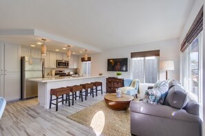 Open floor plan with living room, kitchen, and dining area