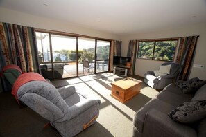 lounge and living area with sliding door to deck area