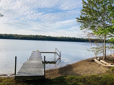 The private beach features a dock, mooring post, swim ladder...