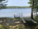 The private beach features a picnic table and fire pit with 6 Adirondack chairs.