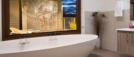 Luxurious stone bath and water feature at dusk