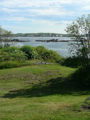 You can see from sitting room/deck across lawn to cove and rocks.