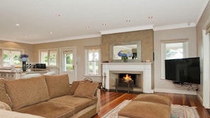 A comfortable living room with a large fireplace (ducted to the master bedroom).