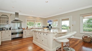 A hand-crafted joinery kitchen with thick granite bench tops.