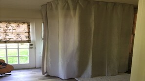 Master Bath.  Clawfoot Tub surrounded by curtains.