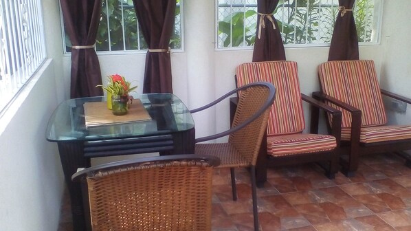 Private patio which overlooks the gardens and front lawn.