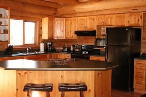 Full kitchen.  Stocked with coffee, tea, sugar, and spices.