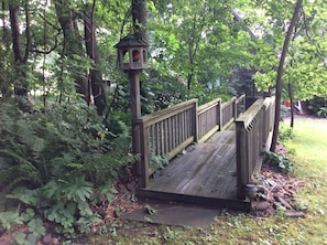 Walk bridge can be seen from the upstairs bedroom follow it down to the lake .