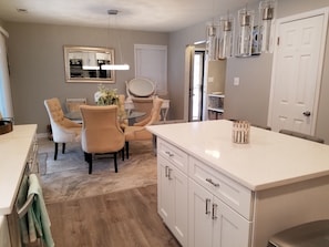 Dining room opening to the kitchen. Doors to the spacious patio.