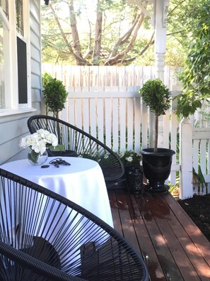 Relax on this front porch overlooking the garden