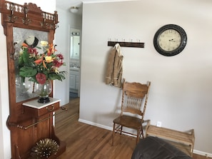 Coat rack and shoe stand in the entry way for your use.