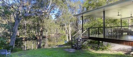 The house revolves around a very large deck in the trees above the river. 