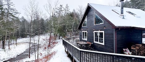 Stay in a winter wonderland overlooking a stream.