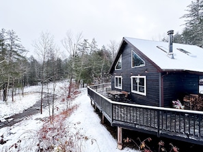 Stay in a winter wonderland overlooking a stream.