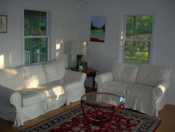 Family Room with large TV, sofa opens to a queen, room is open to kitchen