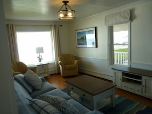 Living room with large picture window overlooking ocean