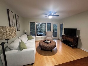 Fully renovated living room w new sofa and recliner.  Panoramic view of lagoon.