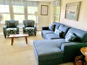 Living room with pocket doors, pullout bed and TV. 