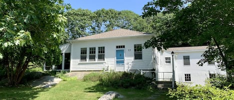 Treetops Cottage.  The screened in porch is hidden by the greenery to the left