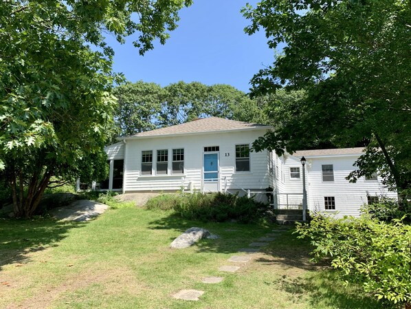 Treetops Cottage.  The screened in porch is hidden by the greenery to the left