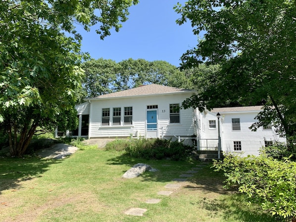 Treetops Cottage. The screened in porch is hidden by the greenery to the left
