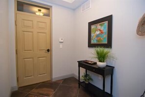 Enter the foyer w/transom window, coat & umbrella rack & alarm system.