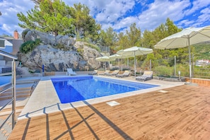 Pool area with loungers and parasols