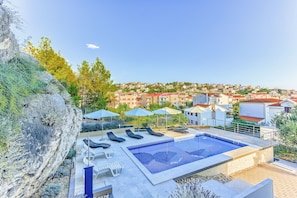 Pool area with loungers and parasols