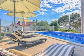 Pool area with loungers and parasols