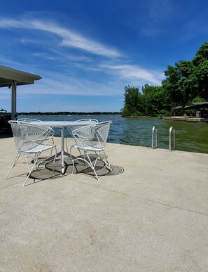 Lakeside patio with table and chairs and swim ladder for easy entry to lake!