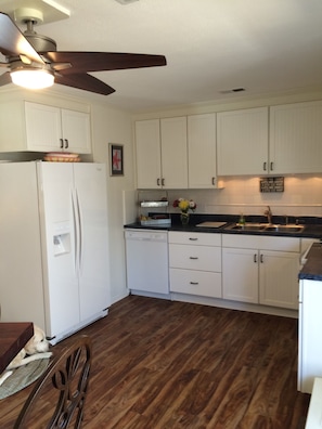 Fresh white kitchen with all new Whirlpool appliances includes dishwasher. 