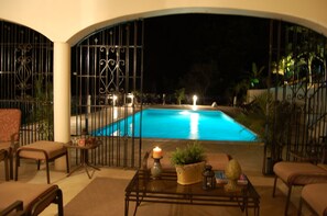 Palashia Villa verandah by the pool at night
