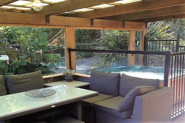 main deck area with seating and hot tub