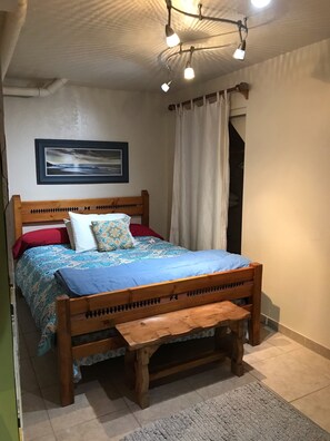 Small guest bedroom with desk & tv with dvds.