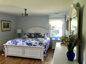 Master bedroom with new floors, furniture, wainscoting and paint!