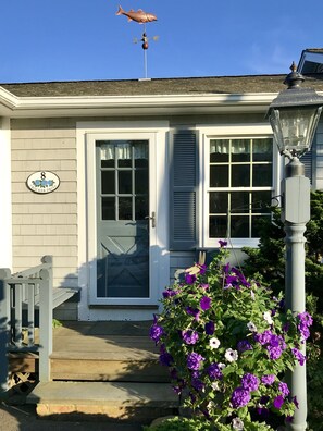 Front steps with striped bass weathervane on the roof