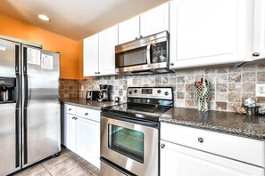 Kitchen with Granite Counter tops & Updated Stainless-Steel Appliances
