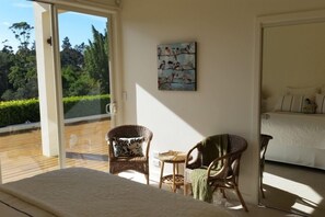 Seating area in bedroom with waterfall view