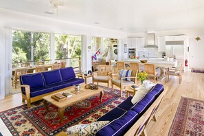 Living area viewing east over east dining porch with 10 foot teak table.