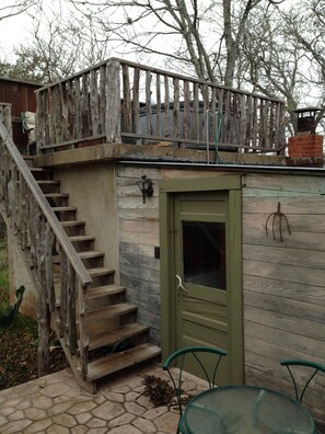 back patio sitting area looking up at hot tub