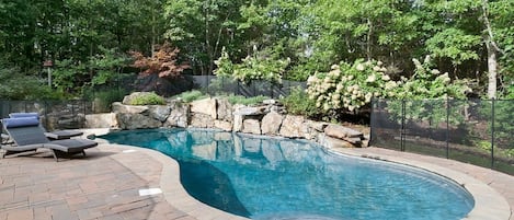 Heated free form gunite saltwater pool (with waterfall) and lush landscaping