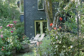 the lower courtyard with lawn chairs amid the gardens