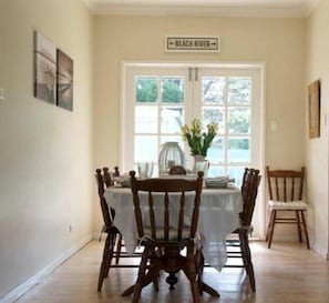 Dining Area With French Doors Opening Out Onto Rear Deck