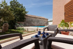 Garden furniture where you can drink coffee or tea while kids enjoy the pool