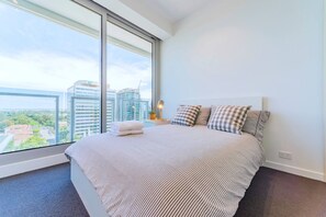 bright bedroom with floor to ceiling window