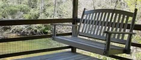 Swing on back porch which overlooks the South Toe River.