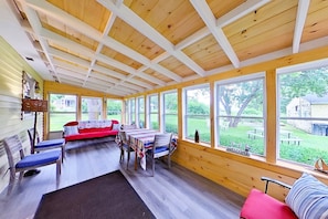 Plenty of space for relaxing, dining or game playing on the enclosed porch.