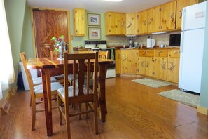 Full kitchen/dining area with Amish built cabinets in the Pine Unit.