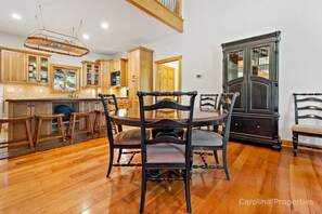 Between the kitchen and the great room is a dining table