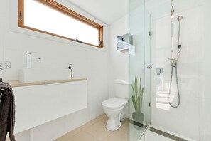 Clean, Modern Bathroom with Walk-In Shower & Monsoon Shower Head.